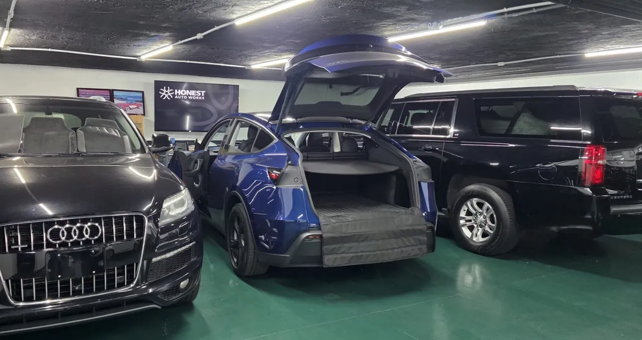 Blue Tesla with open rear hatch for Tesla accessories installation at Honest Auto Works in Miramar, San Diego